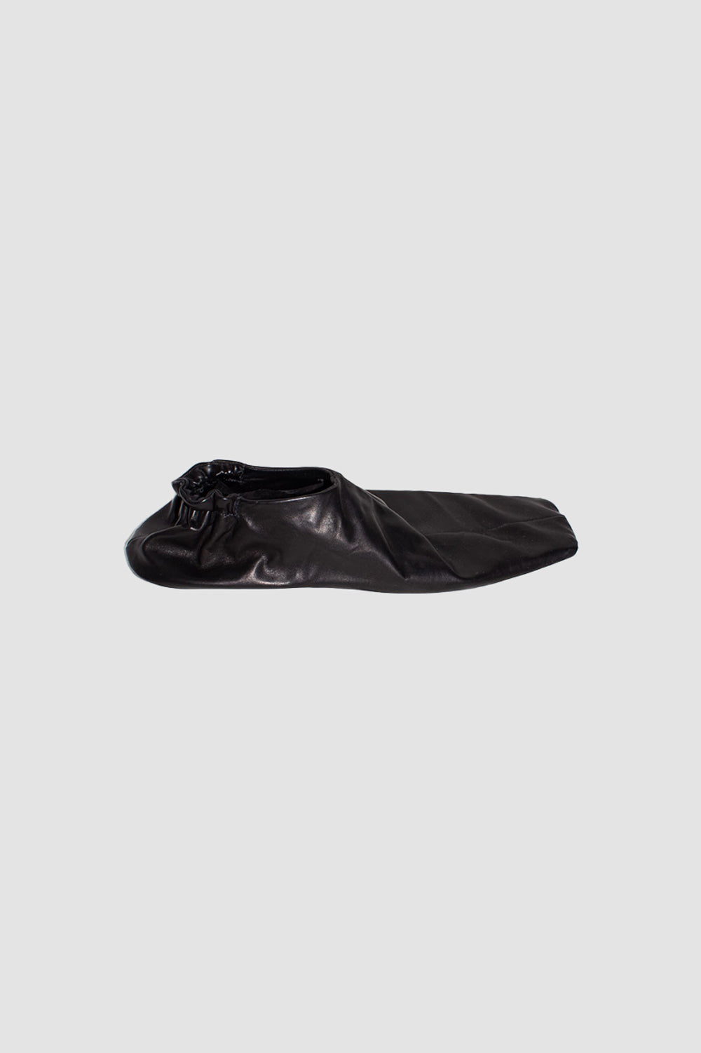 Black horse leather slip-on shoe with square toe and elasticated heel, side profile view