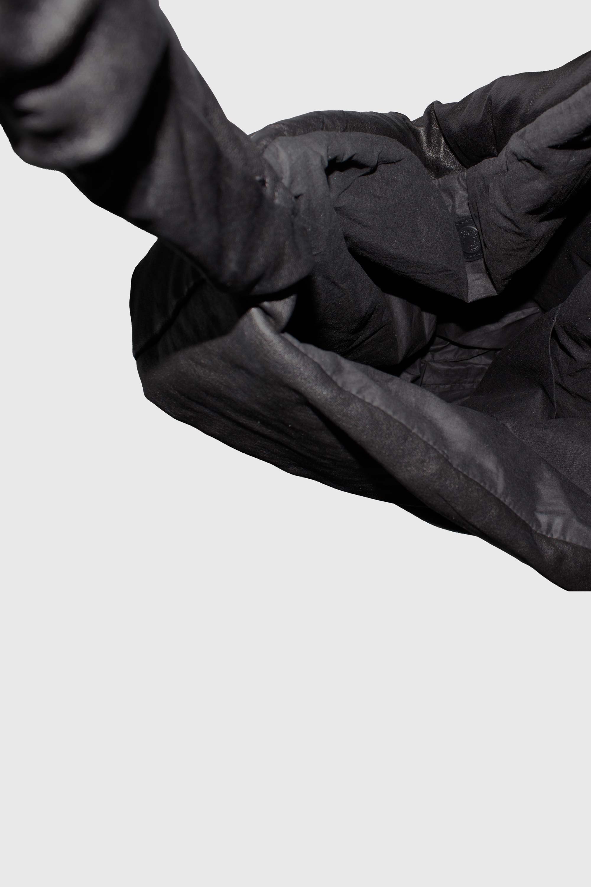 Close-up detail of ruched leather bag straps and soft construction