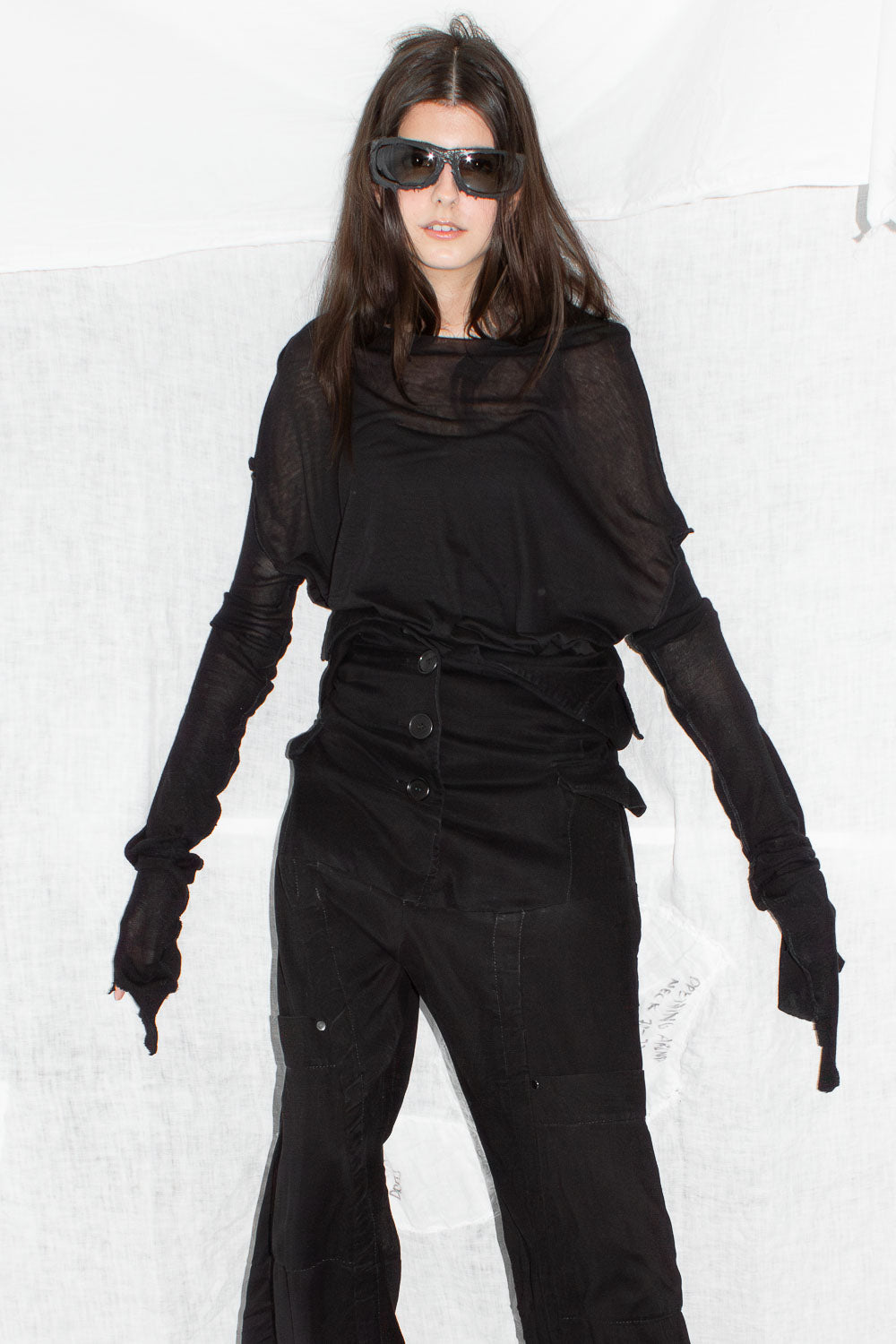 Model wearing silk top with sunglasses showing styling and fit