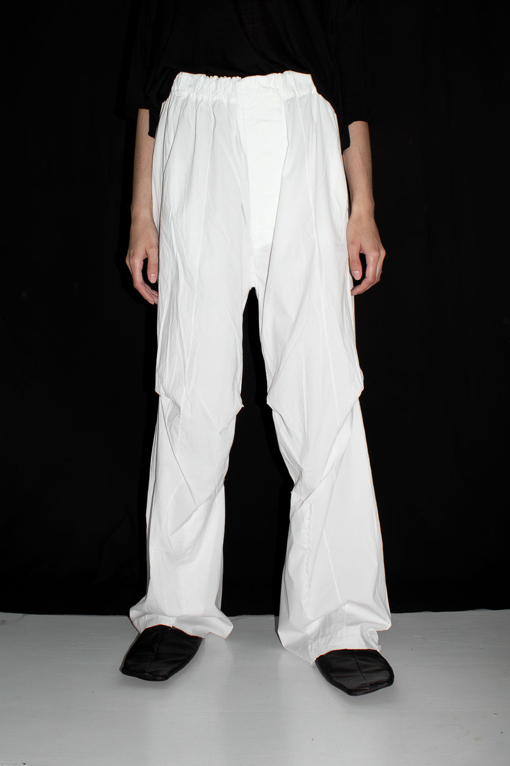 White loose straight slacks with slight flare on model, front view