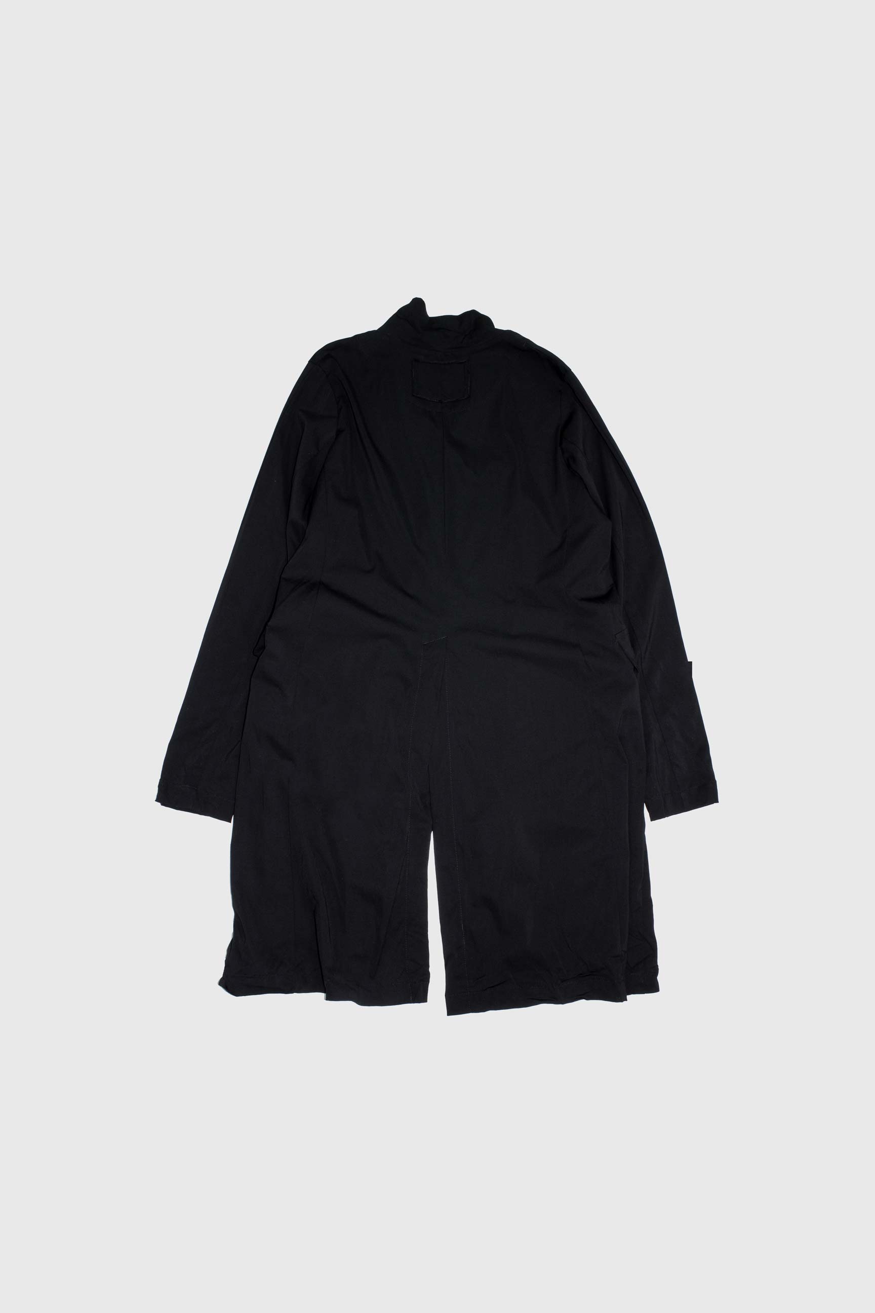 Back view of black coat showing relaxed straight silhouette and center back vent detail