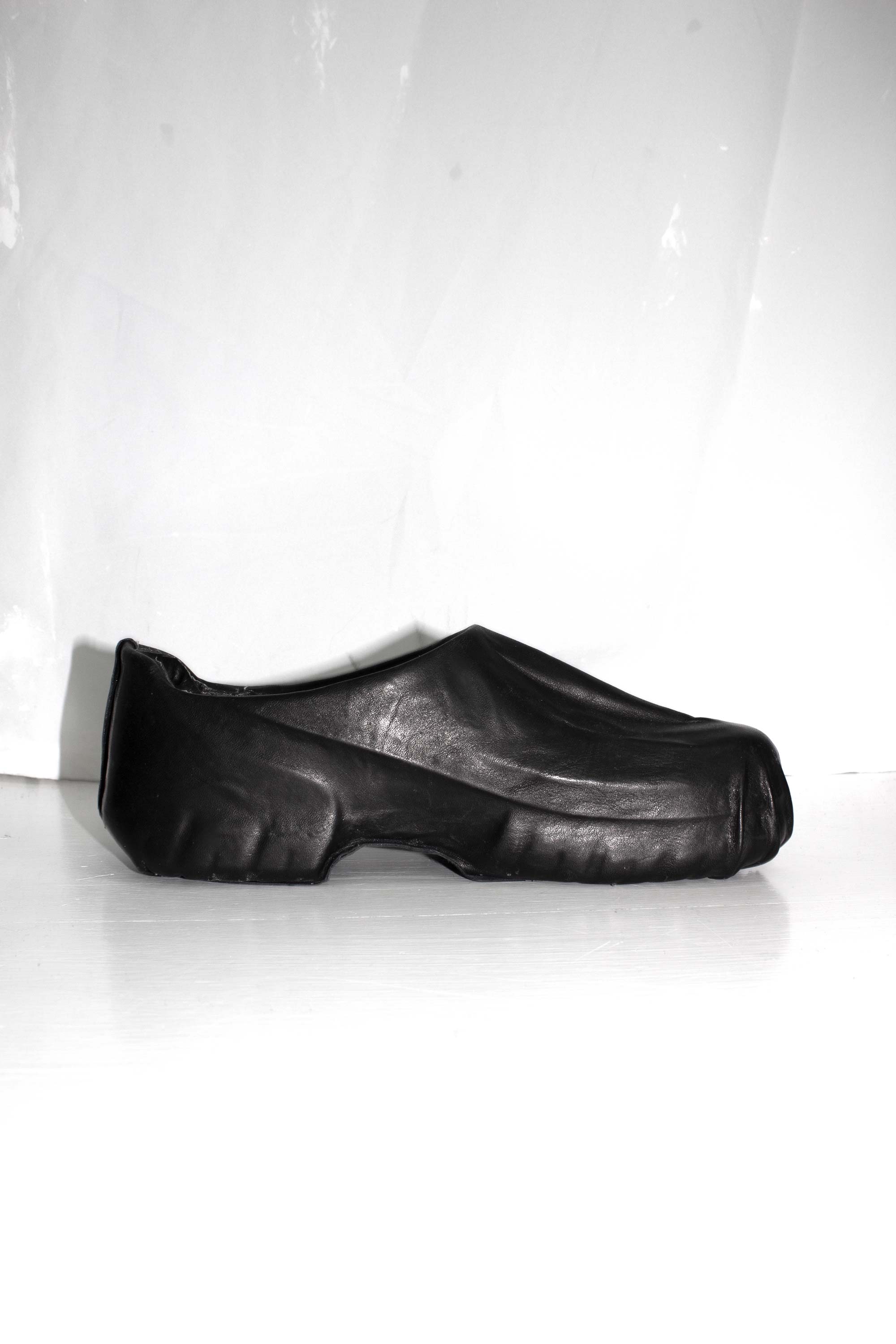 Single black wrapped clog shown in profile against white background