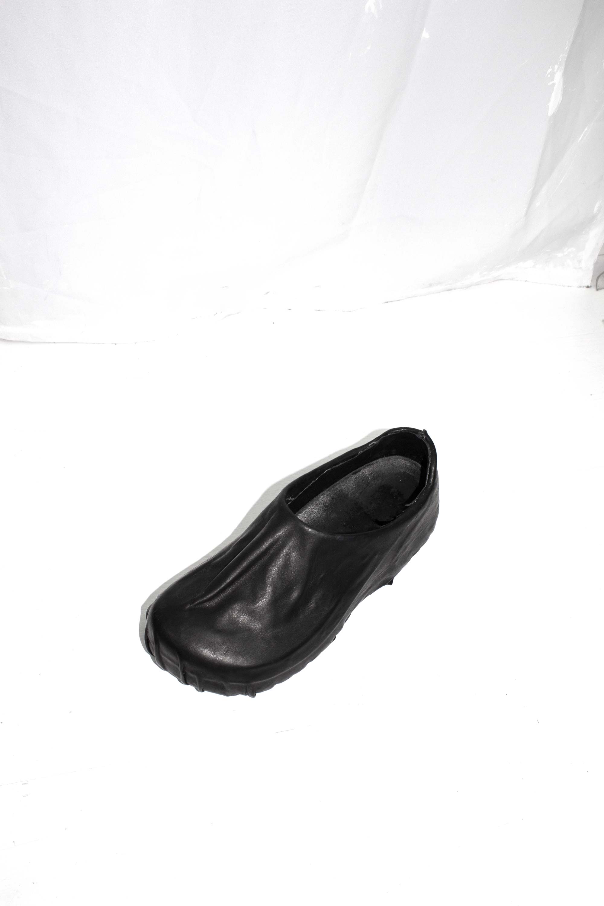 Black wrapped clog photographed from above showing opening and treaded sole