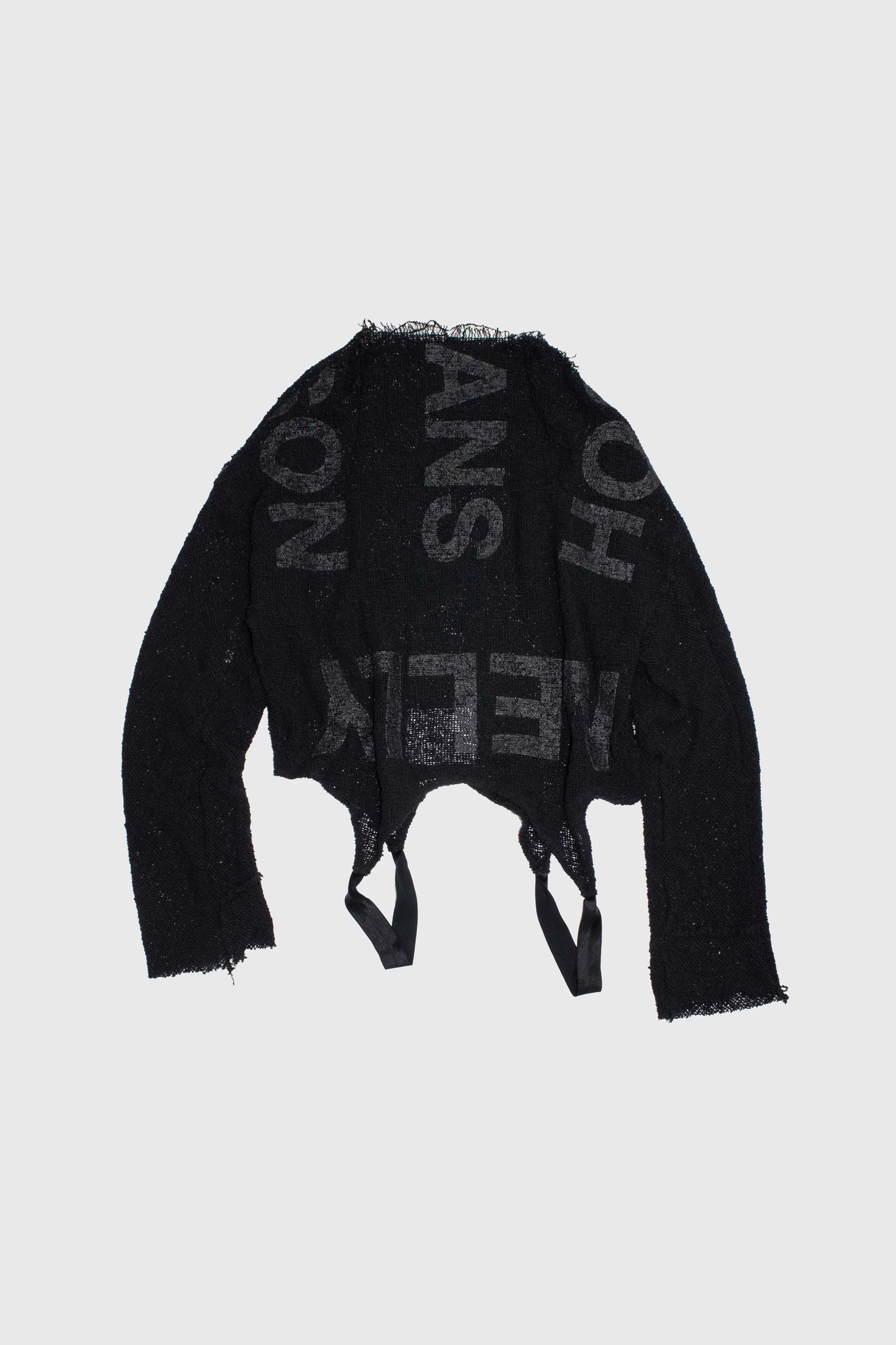 Black mesh knit sweater with graphic text print laid flat, showing raw hem with side ties