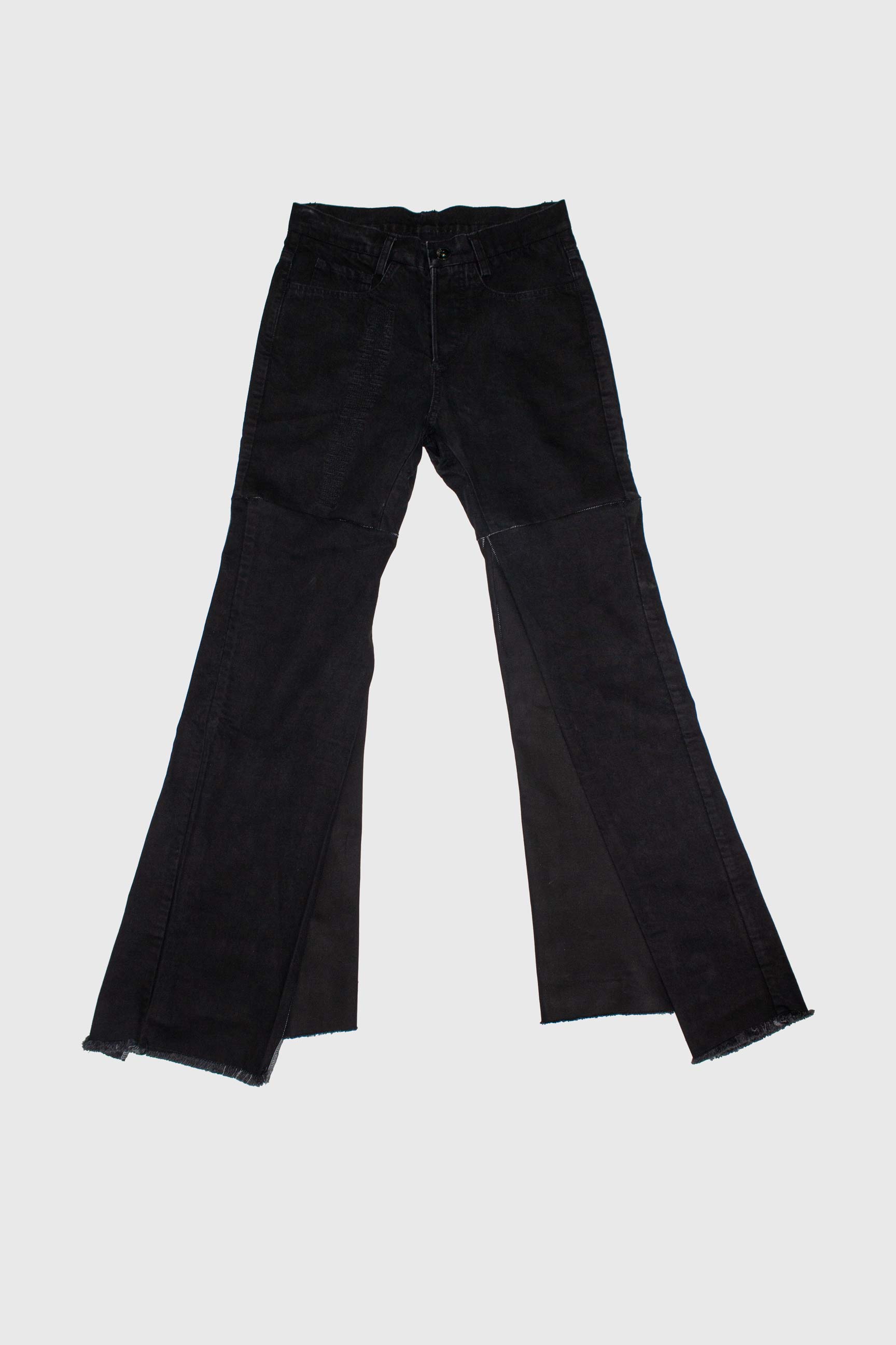 Black flared denim trousers laid flat showing front view with triangular panel construction