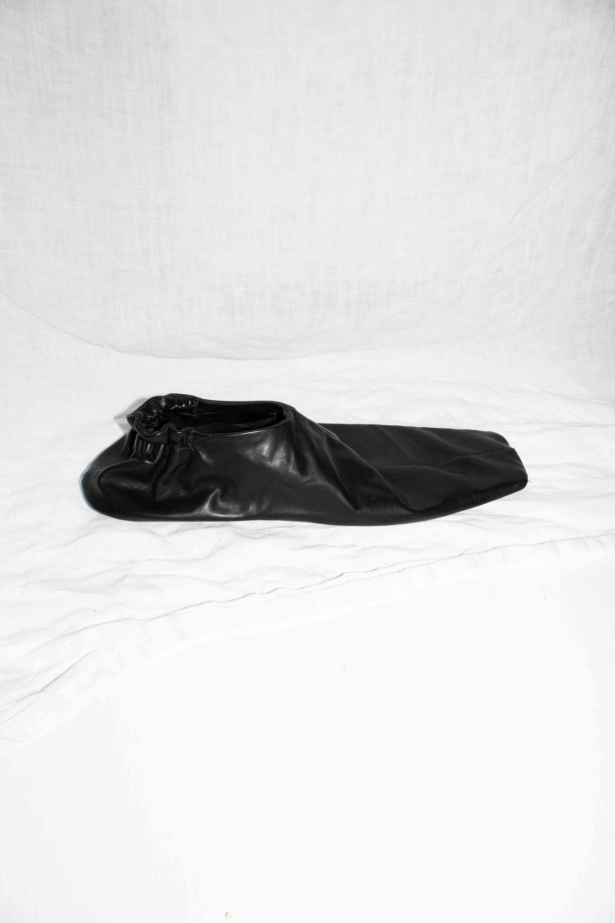 Black horse leather slip-on shoe with square toe and elasticated heel, side profile view – Slip On Shoe by NELLY JOHANSSON