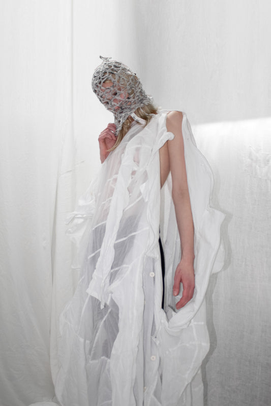 NELLY JOHANSSON 2023–24 collection: black sculptural mask with a white draped dress 2