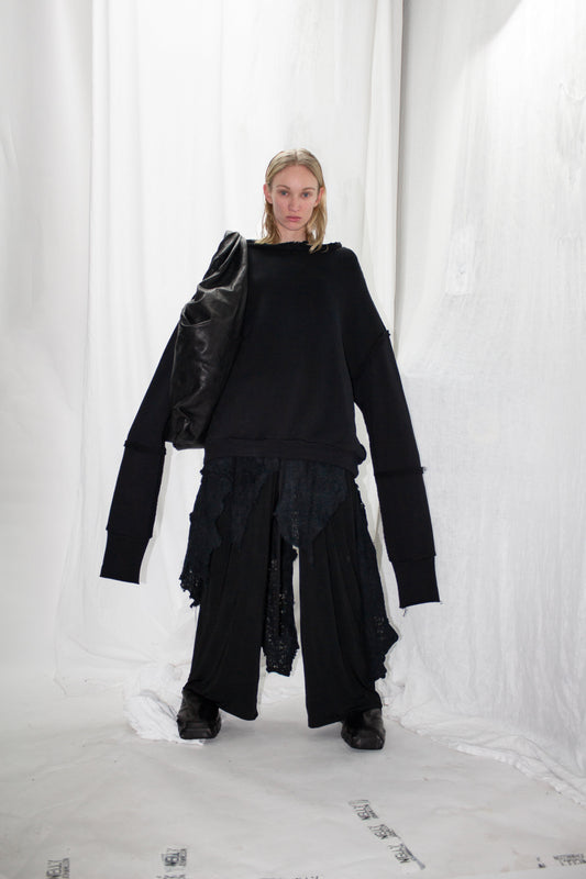 NELLY JOHANSSON 2023–24 collection: oversized black coat with long sleeves over wide trousers 3