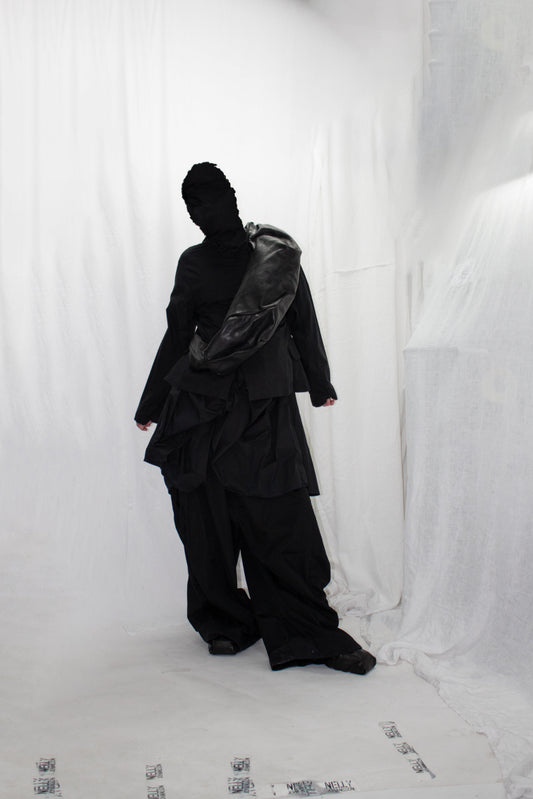 NELLY JOHANSSON 2023–24 collection: masked model in a black jacket and voluminous trousers 15