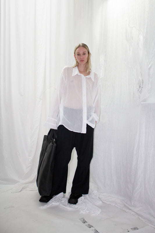 NELLY JOHANSSON 2023–24 collection: sheer white shirt with wide black trousers and black bag 16