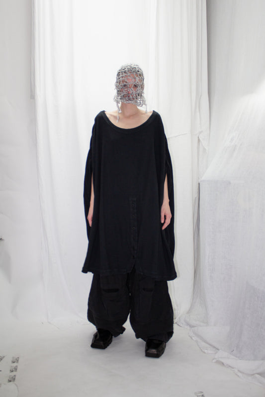 NELLY JOHANSSON 2023–24 collection: masked model in a black tunic and wide black trousers 26