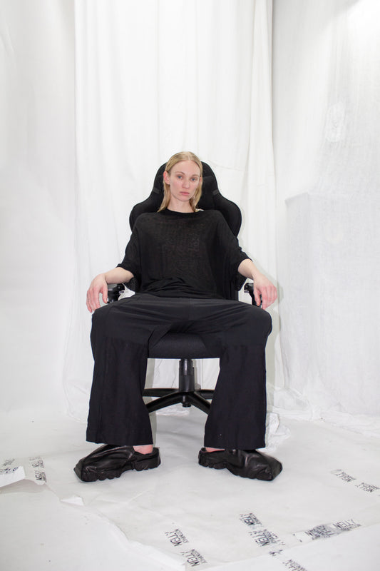 NELLY JOHANSSON 2023–24 collection: model seated on a black chair in an all-black outfit 28