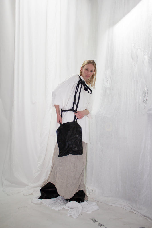 NELLY JOHANSSON 2023–24 collection: white top and white skirt with a black bag 39