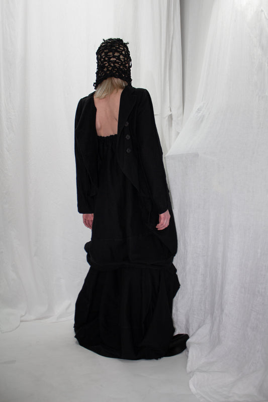 NELLY JOHANSSON 2023–24 collection: masked model in a long black open-back dress 48