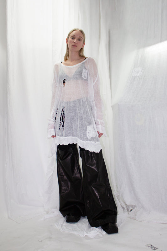 NELLY JOHANSSON 2023–24 collection: white sheer knit top with wide black trousers 54