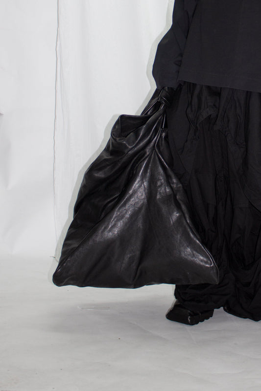 NELLY JOHANSSON 2023–24 collection: voluminous black leather bag with a black skirt 55