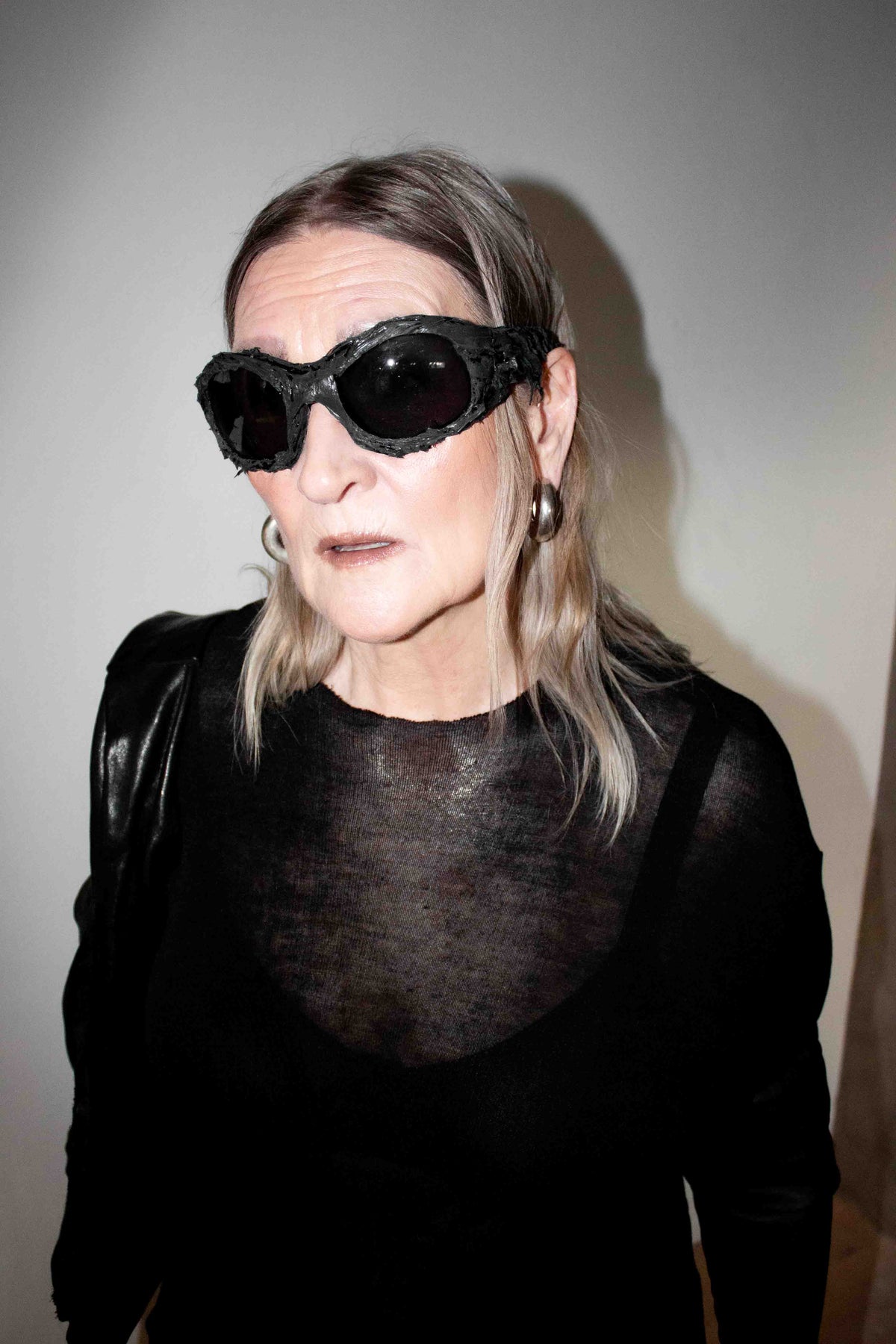 Portrait of Nelly Johansson, founder and designer, in sunglasses and a sheer black top – NELLY JOHANSSON 2024–25