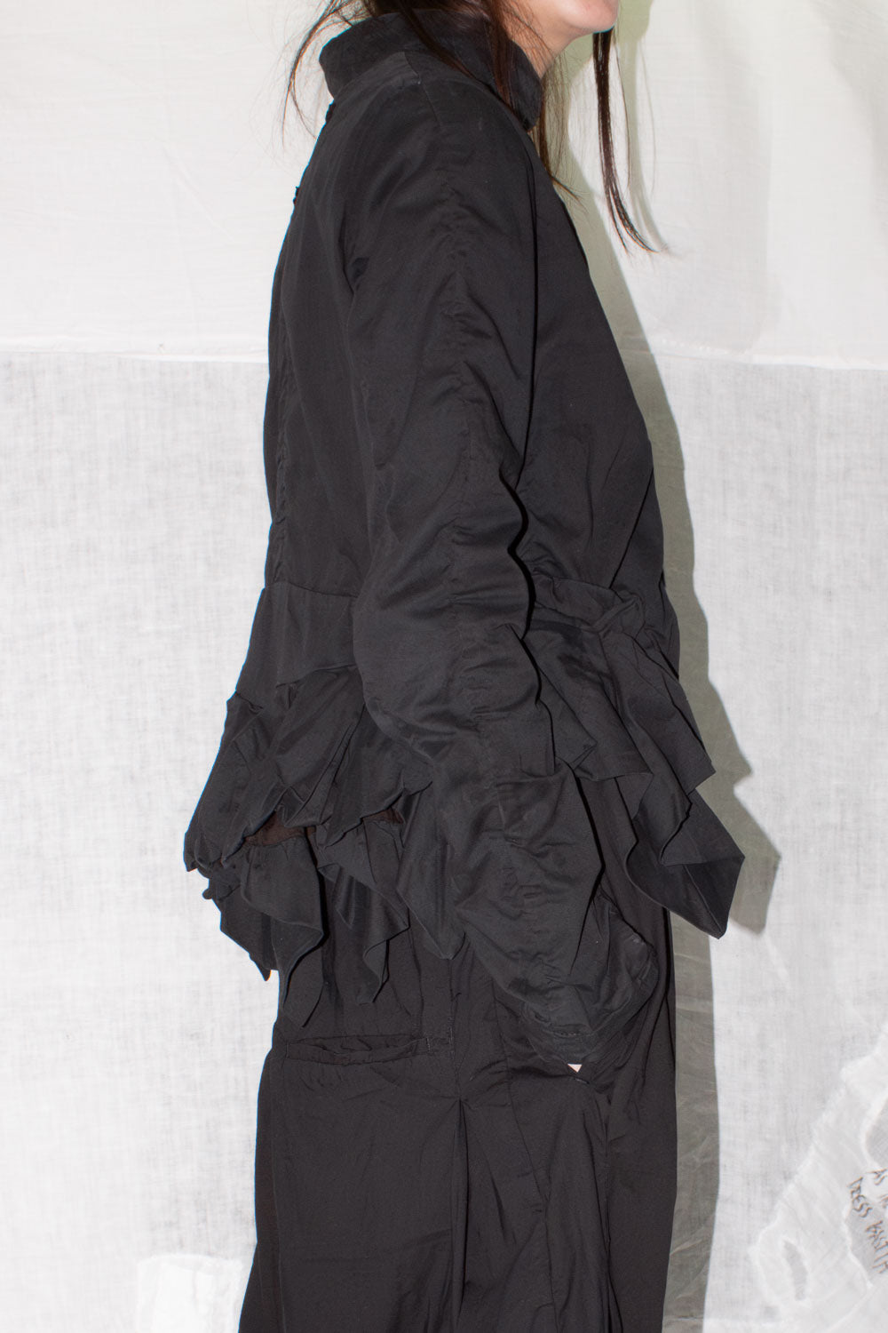 Side profile showing exaggerated ruched pockets and layered construction details