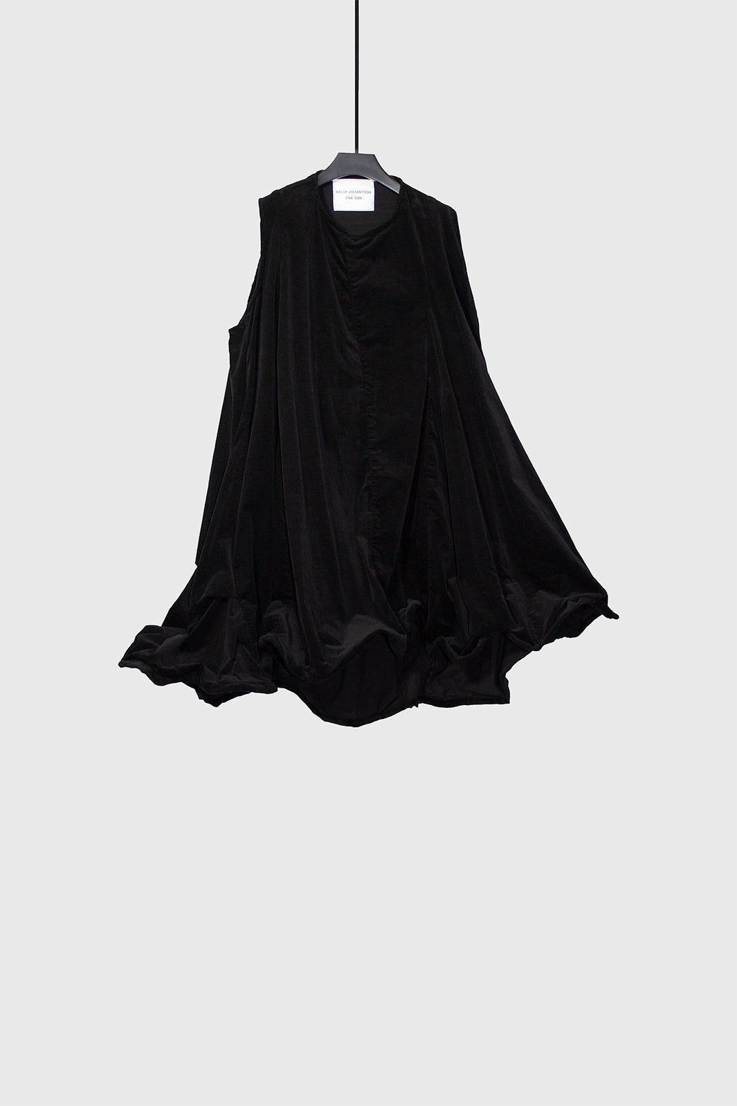 Black sleeveless dress hanging on hanger showing A-line silhouette and wire-structured hem