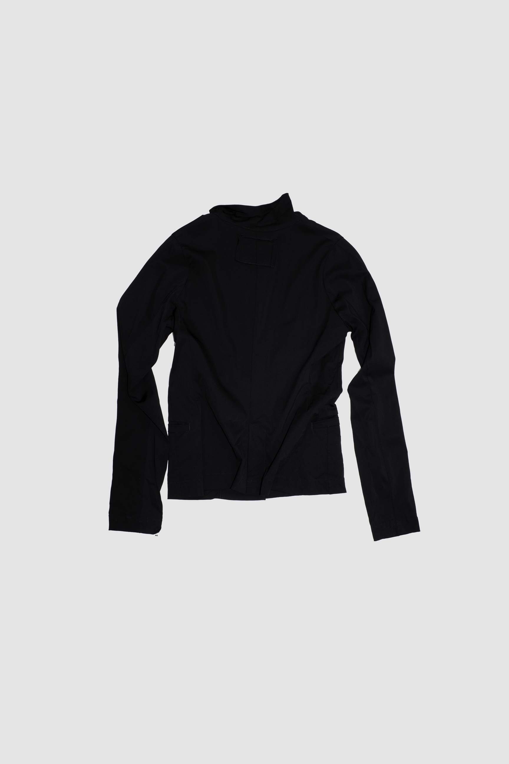 Black tailored jacket back view flat lay displaying clean construction and fitted shape