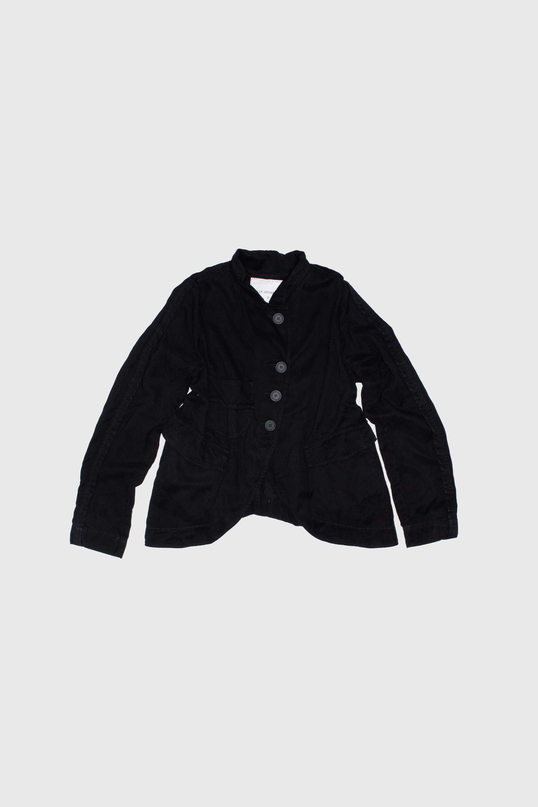 Black deconstructed jacket flat lay showing four-button front and asymmetric construction
