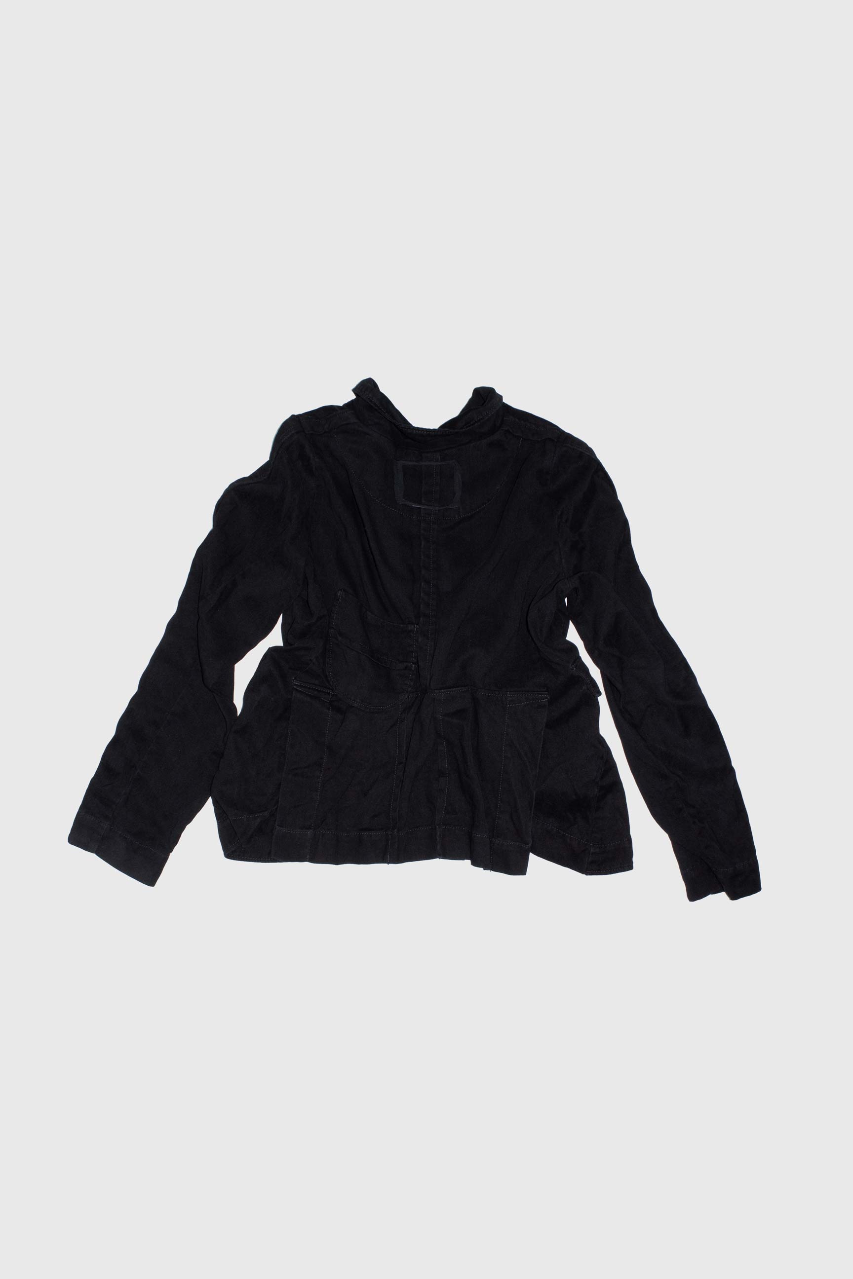 Flat lay back view of jacket showing seam details and raw hem construction