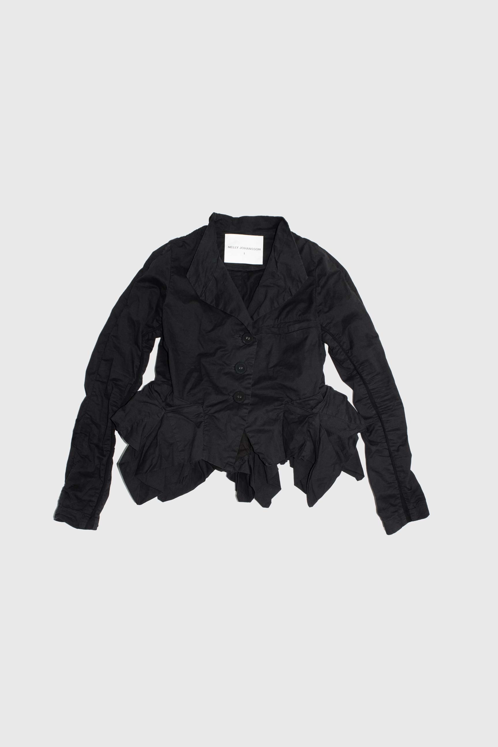 Flat lay showing complete jacket silhouette with ruched waist and irregular hem