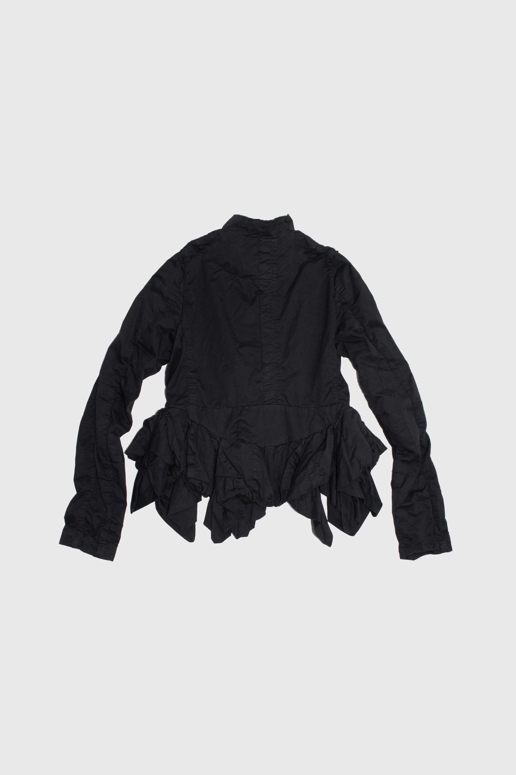 Back view showing architectural volume and ruffle details at waist