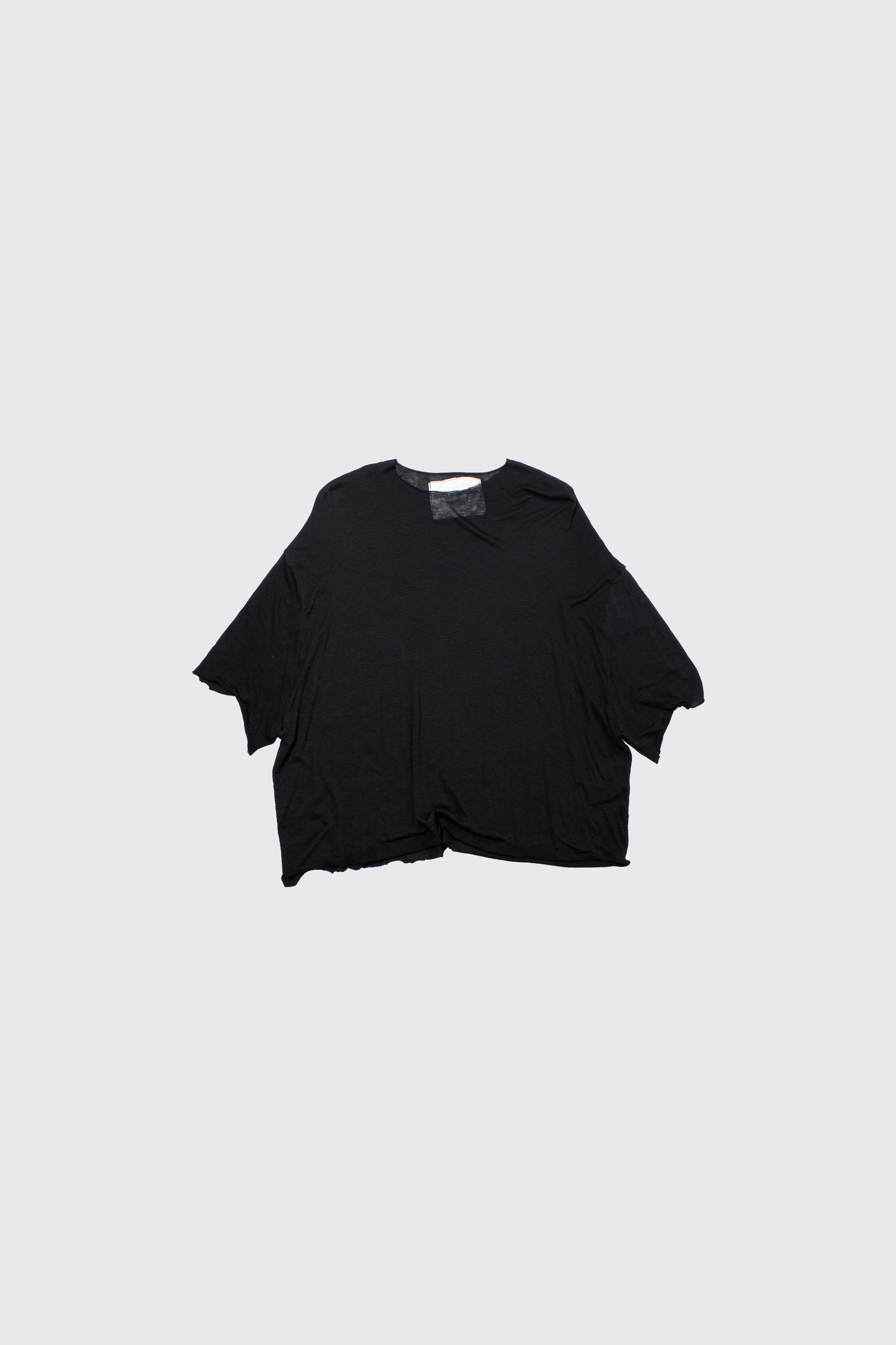 Black t-shirt laid flat showing oversized silhouette with wide sleeves and raw hem details